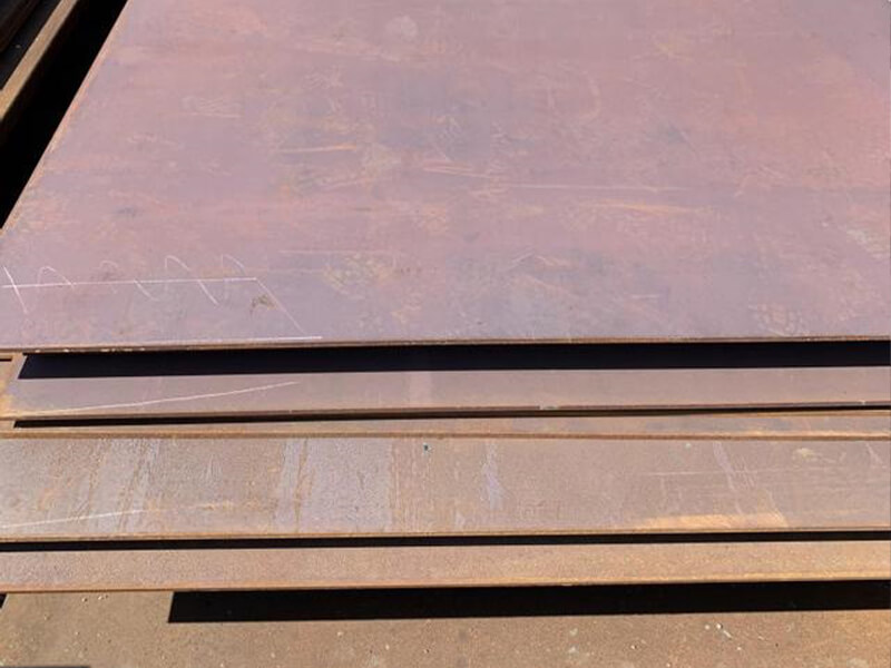 Technician performing ultrasonic test on steel plate