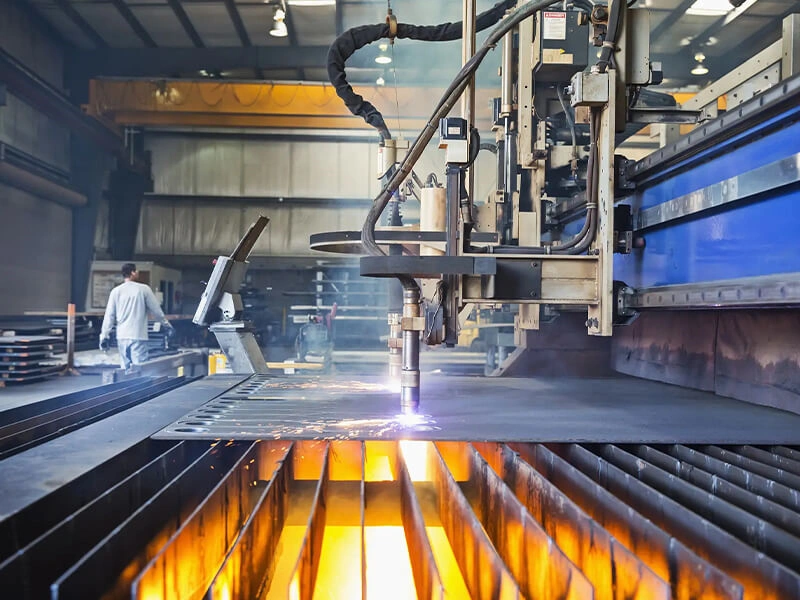 A modern steel mill with molten steel being poured