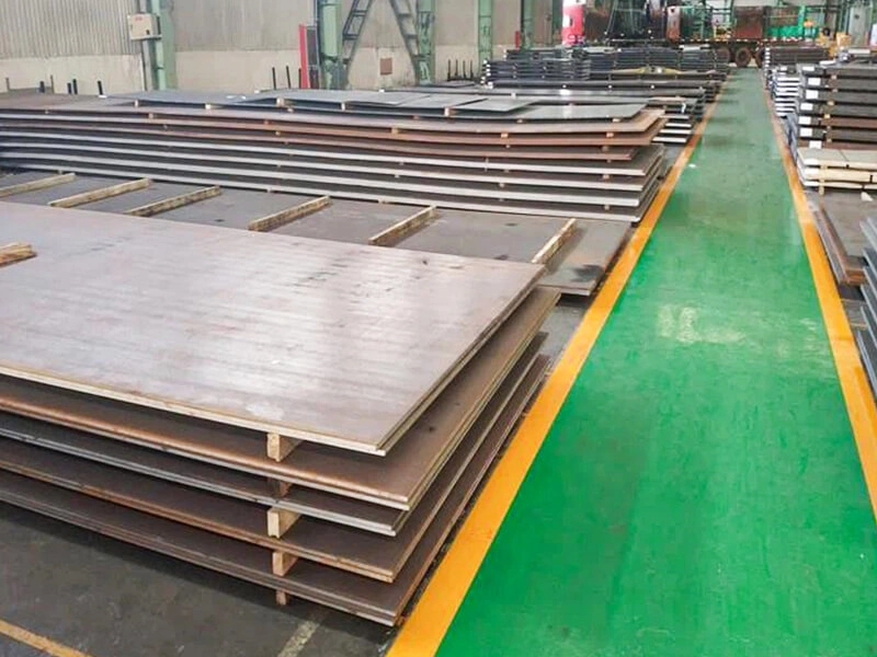 Marine steel plates stacked in a warehouse ready for shipment