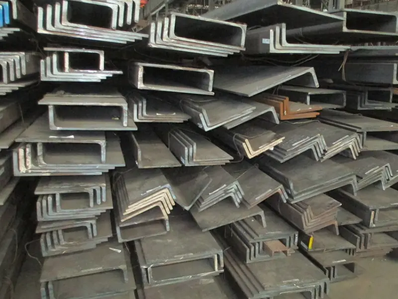 Bulb flat steel sections stacked at marine fabrication yard for offshore platform construction