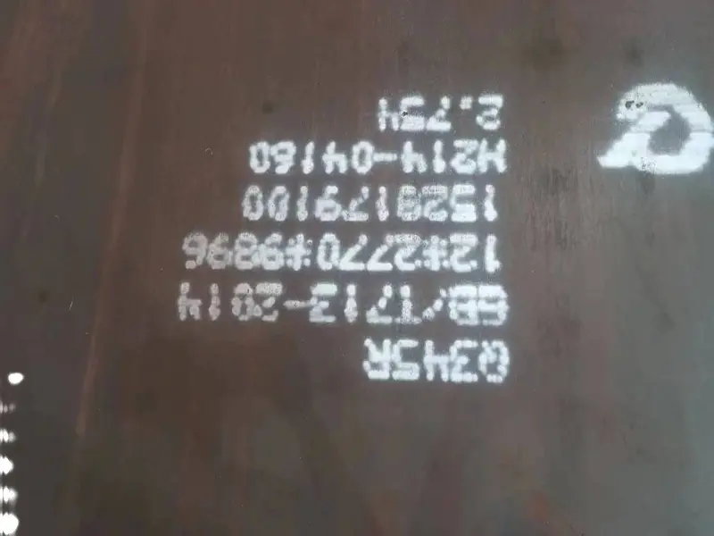 Class surveyor rejecting a steel plate with a red stamp while workers watch
